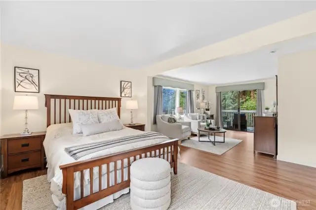 Expansive oversized primary suite with private sitting area, walk-in closet, deck, and ensuite.