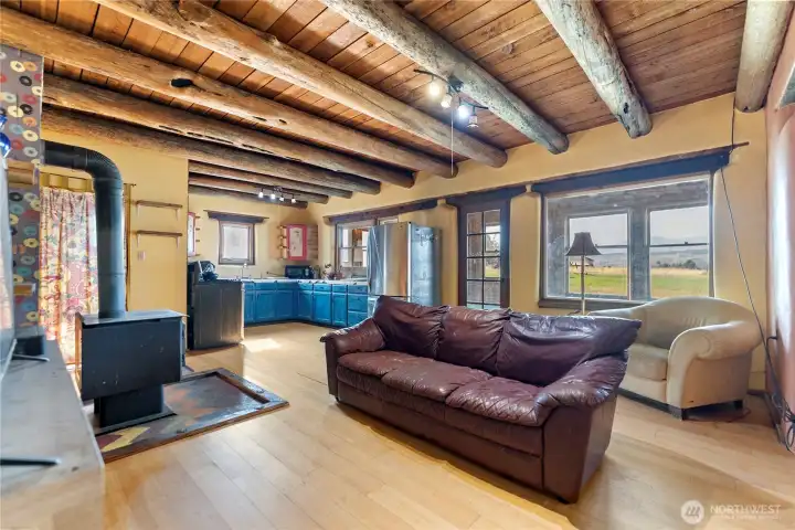 Exposed beam ceilings and wood burning freestanding stove.