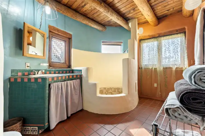Artistic flair with your heart shaped shallow tub and shower space.