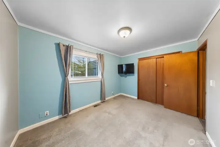 primary bedroom, hardwood floors beneath carpet