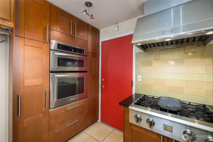 Oven, microwave and lots of storage... Red door leads into garage storage area. (not full size as half of garage was used for new bathroom addition)