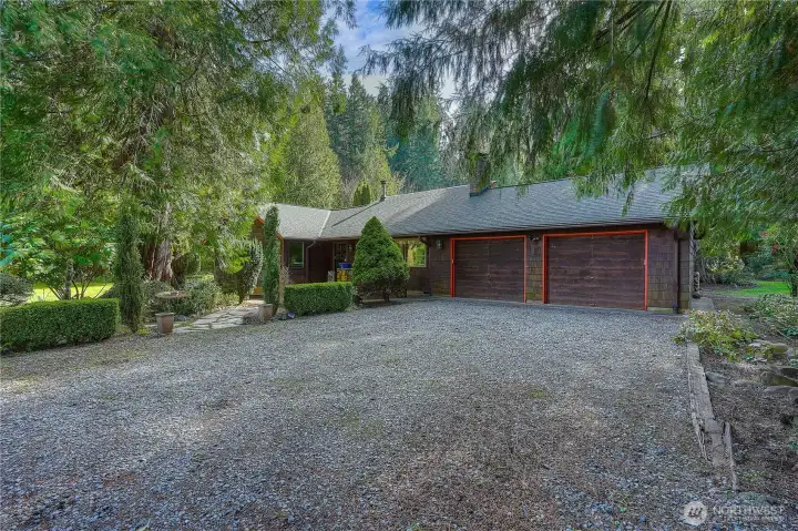 Two car garage with generous driveway offering privacy, space and ample parking space.