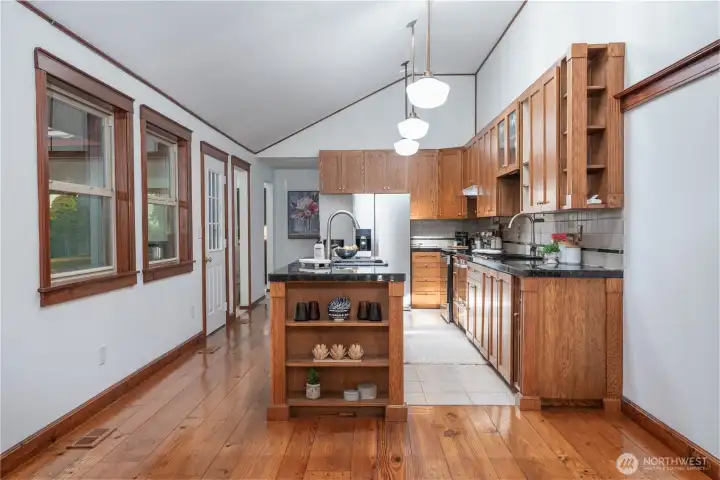 Thoughtfully designed for easy flow and functionality, this kitchen offers seamless access from the main living areas, making it ideal for both everyday living and entertaining. The open layout, center island, and adjacent dining space create a natural gathering point, while wide walkways and abundant natural light enhance accessibility and comfort throughout.