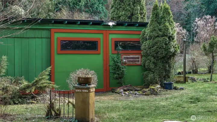 Detached shop/outbuilding offers versatile space for storage, hobbies, or workspace needs.