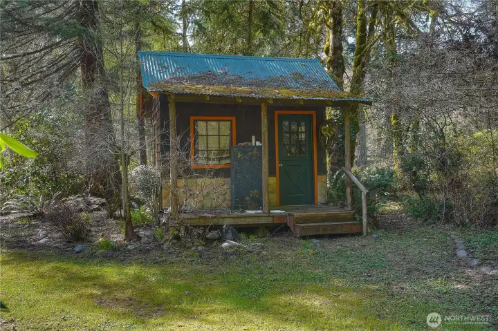 Charming rustic cabin nestled among the trees offers a cozy, private retreat full of character. Ideal for a studio, workspace, or quiet escape surrounded by nature.