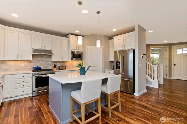 Lovely island with  Quartz Countertops and electrical plug in for heating food while entertaining!