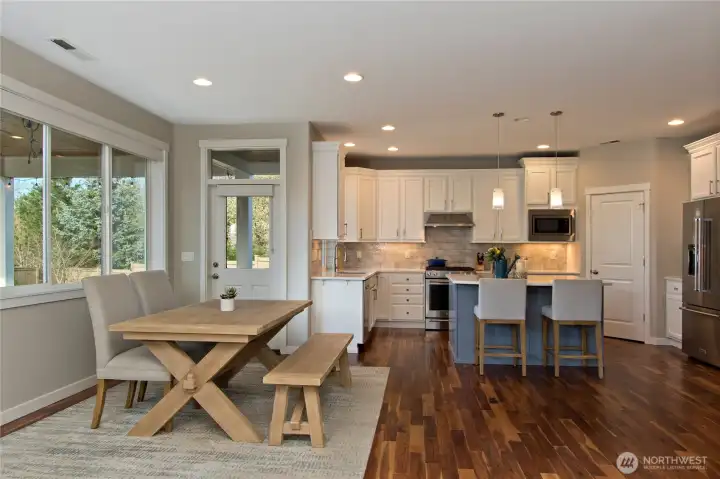 Light and Bright dining area overseeing the beautifully landscaped yard.