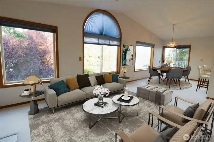 The main floor living and dining area, virtually staged, with natural light and views of the water and mountain framed right through the windows.