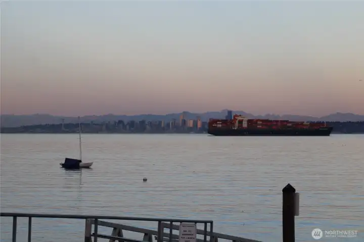 A cargo ship moves through the Sound near Manchester at sunset, a reminder that this is a working waterway as much as a scenic one.