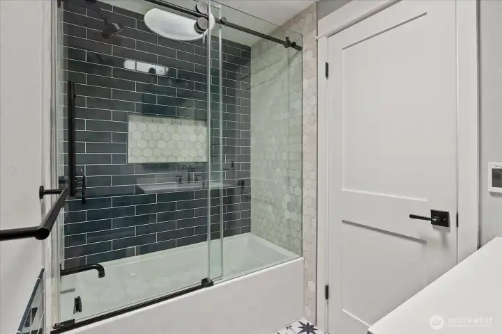 Guest bathroom - Enjoy the deep soaking tub with marble tile surround