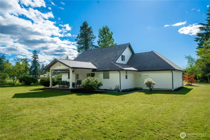 Huge, level backyard is fully fenced and ready for lawn games, fury friends, or lounging.