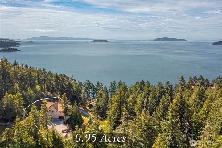 Aerial perspective highlights the home’s private 0.95-acre setting and sweeping views across San Juan Channel toward neighboring islands.