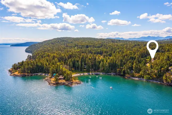 Aerial view shows the property’s location near community beach access and the protected waters of the surrounding San Juan Islands.