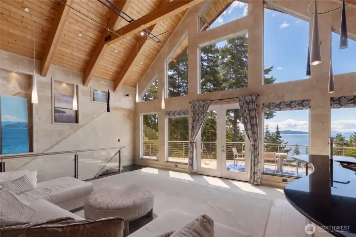 French doors open the great room to the expansive deck, extending the living space toward panoramic San Juan Channel views.