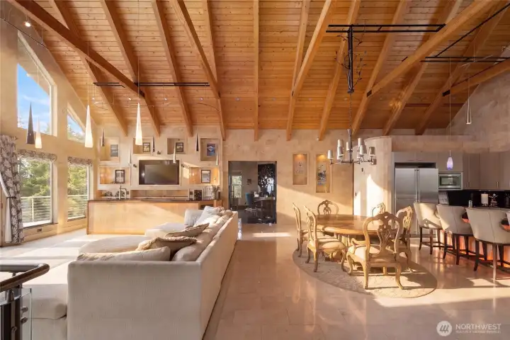 The spacious open floor plan connects the living room, dining area, kitchen, and custom bar for effortless gathering and entertaining.