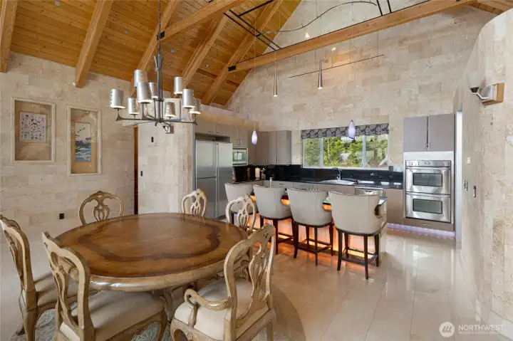 Formal dining space opens to the chef’s kitchen, featuring generous counter space, island seating, and a walk-in pantry.