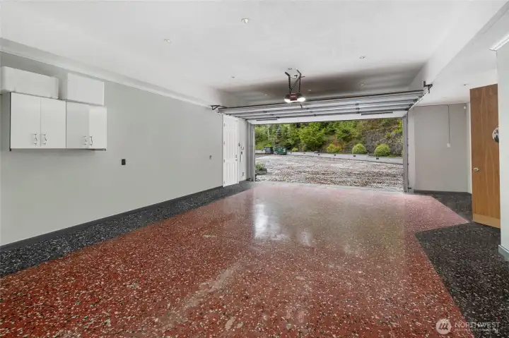 Large tandem garage provides substantial vehicle and storage capacity with a wide overhead door and direct access to the home.