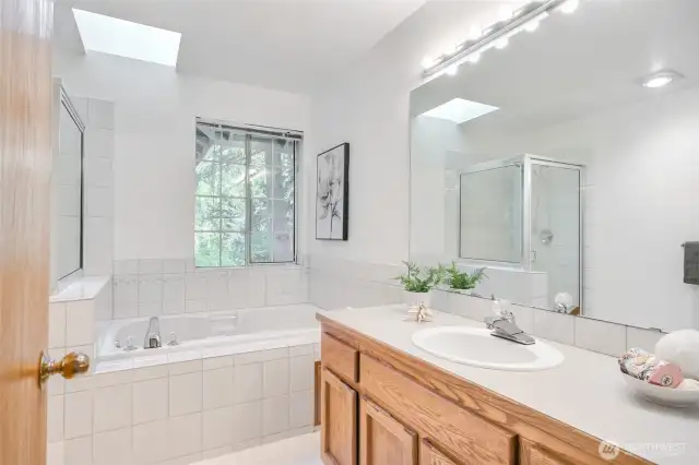 Primary bath 5-piece bathroom with jacuzzi tub.