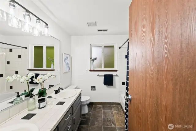 Slate floors, tile counters and tile tub surround.