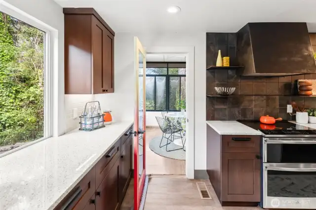 Just off the kitchen is a sunroom that is perfect for an eating space, an art studio or an office!
