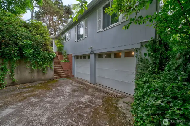 2 car garage with stairs to the entrance.