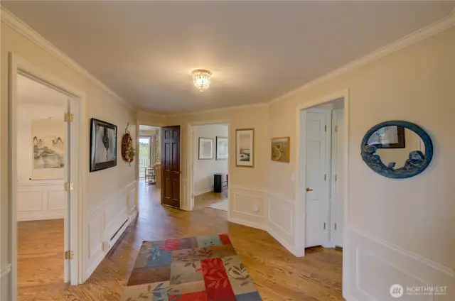 Main Entryway. Door to the left goes to the formal dining room, next door goes to the kitchen and dining room, center door is the main family room, door to the right goes down the hall to the bedrooms.