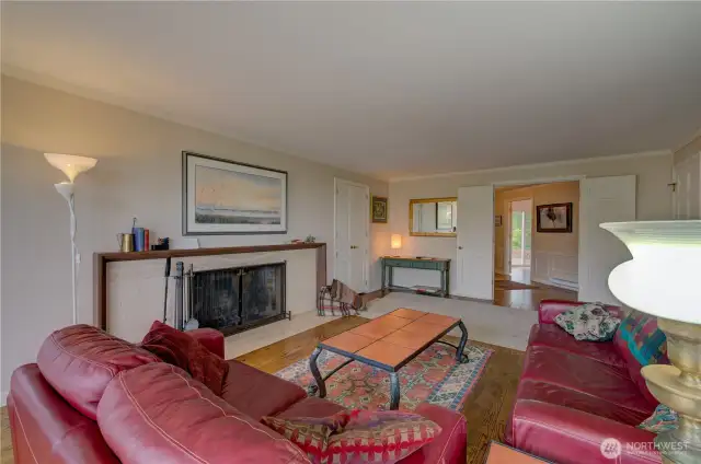 Family room with fireplace and access to the wrap around porch. Double doors go the main entryway.