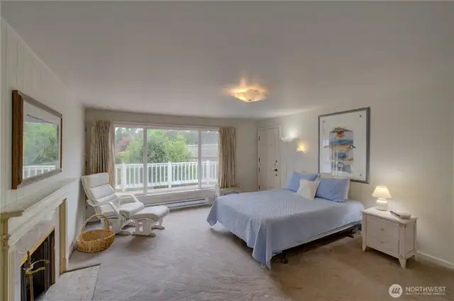 Primary suite with Dutch door to the wrap around deck. Check out he fireplace.