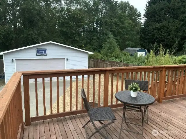 The peaceful view from the deck overlooking the back yard and garage.