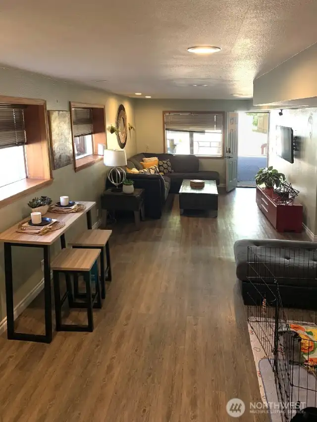 The fully finished lower level great room. Walk out to the partially covered back patio with covered hot tub and partially fenced back yard.