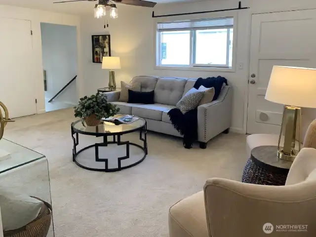 Here you can see the entry way to the living room. The door to the right has been modified for use of a floor standing AC unit. - Not supplied or included. The door in this photo is one way to access to the large back deck. Perfect for when you have guests over and prefer to keep the bedroom access to the deck private.