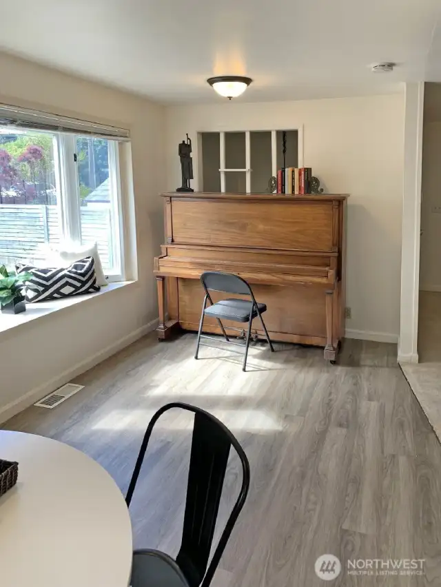 The other end of the dining room. The full size piano can stay if you want to keep it. This might be a sign that you or someone you know would like to learn how to play the piano.