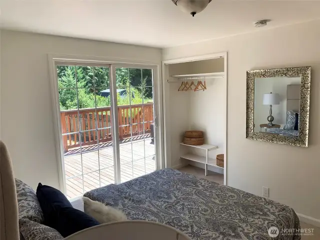 Here you can see more of the bedroom and back deck. Wake up to the morning sun shining in.