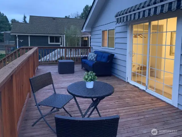 There are stairs down to the back yard and covered hot tub from the deck.