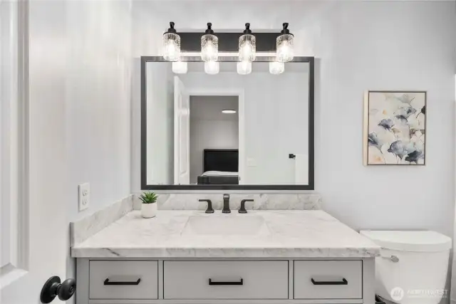 Updated primary bathroom with a huge vanity mirror.