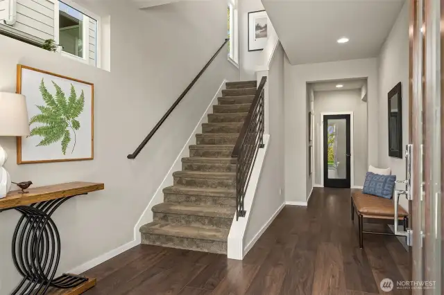 Warm luxury engineered hardwoods greet you at the expansive foyer.