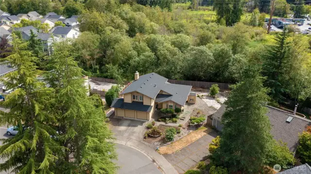 Home is in the foreground and look at the private green belt behind the house