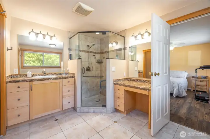 Primary bath with large walk-in tile shower and 2 vanities.
