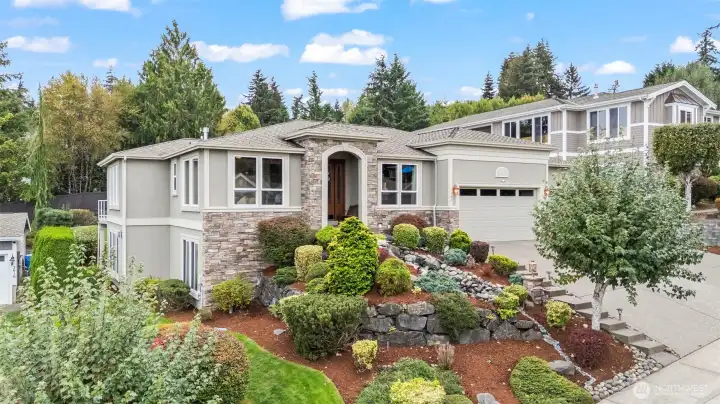 Beautifully landscaped front elevation in Grace Cove, showcasing refined architecture, stone detailing, and manicured gardens in the heart of Gig Harbor, WA