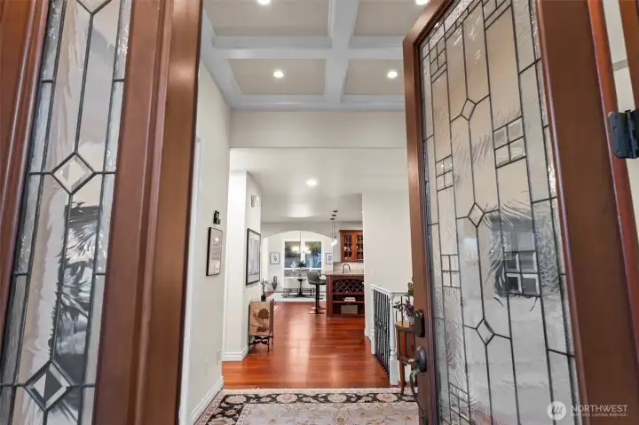 Grand foyer with coffered ceilings and hardwood floors, introducing the home’s timeless design and effortless main-floor living flow