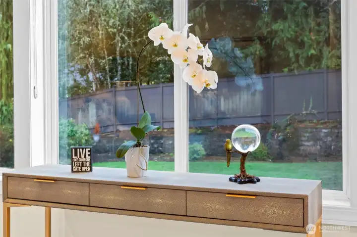 Serene garden outlook from the primary suite, offering peaceful morning light and a lush natural backdrop.