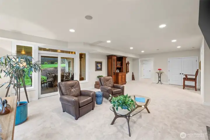 Spacious media/family room with walkout access and room for multiple gathering zones—versatile and welcoming.