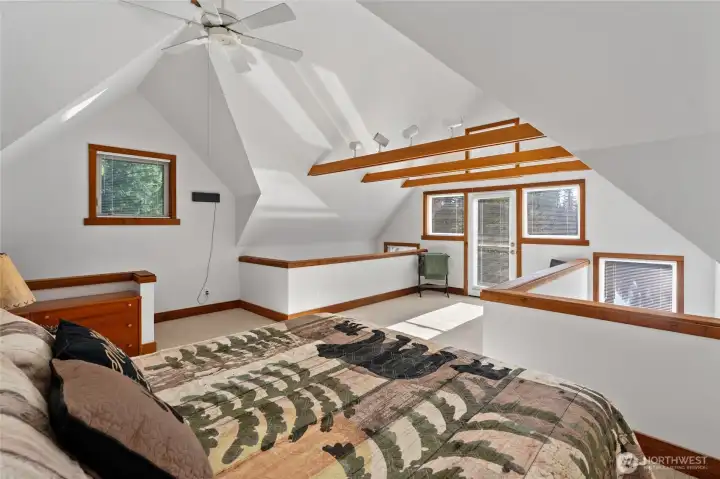 Soaring ceilings with exposed beams in loft area