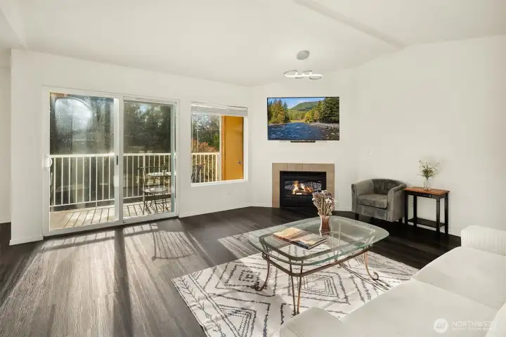 Enjoy the vaulted ceilings over the living room. This South Facing Upstairs Unit provides a nice light filled   atmosphere! The sliding glass doors lead out to the back deck.