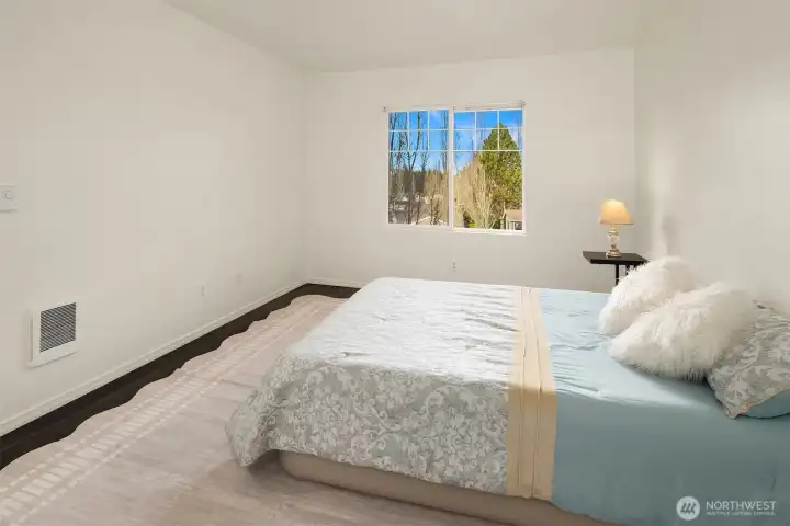 Primary Bedroom Suite w/ Laminate wood flooring
