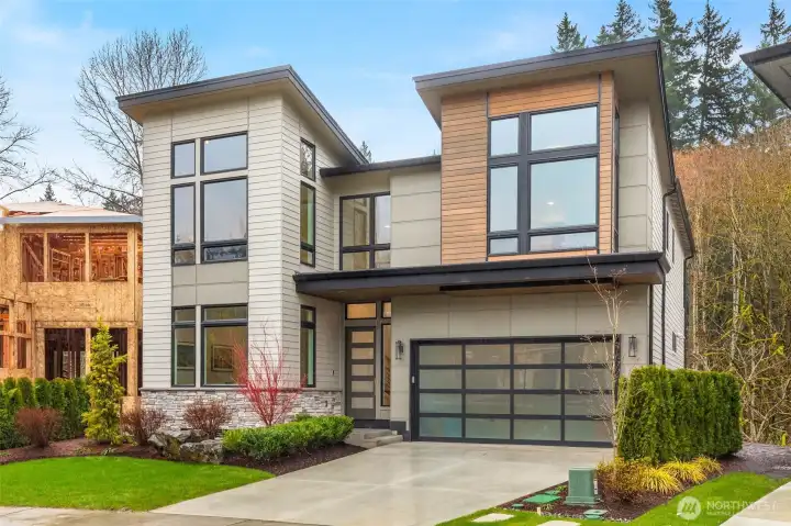 Soaring window walls on both sides of the home funnel natural light throughout the residence while open to territorial views. Front of the home looks out onto the community great lawn while the back faces the protected greenbelt and Tibbetts Creek