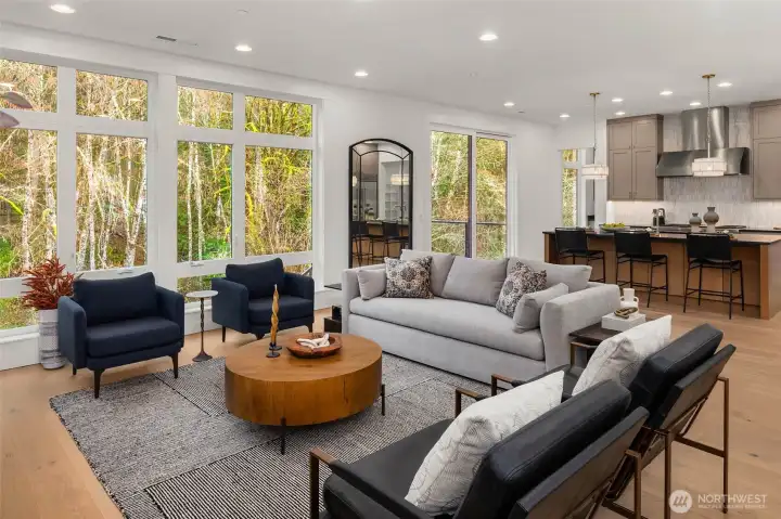 Family room open to chefs kitchen and sliding glass door open to greenbelt backing deck