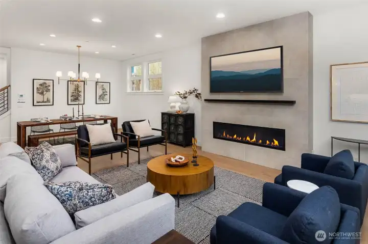 Dedicated dining space off living room with designer selected hanging light fixture