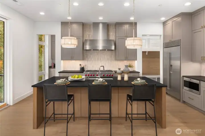 Chefs kitchen features 48" duel fuel Wolf Range with 6 burners, infrared griddle, and double oven, built in 42" Sub zero refrigerator, subzero undercounter beverage fridge, in counter Wolf Microwave drawer, and sleek and quiet stainless steel cove dishwasher