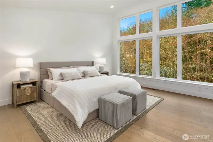 Primary features wide plank hardwood floors. Hardwood floors used extensively throughout the home including entire first floor, stairs, upper hallways, upper level rec room, and Primary Suite